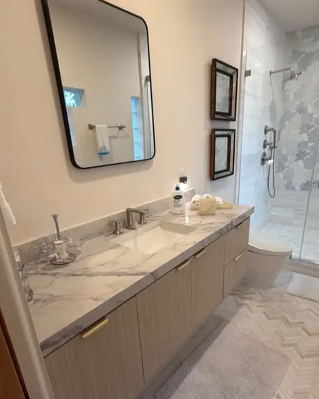 After: Bathroom with wood vanity & glass shower